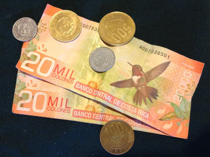 20 thousand colones bills paper money with butterfly design and coins from Costa Rica