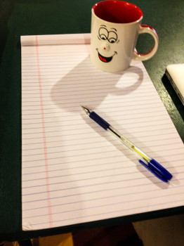 Pen Coffee Cup and Pad of Paper to Write Down Tips to Save Money Before Your big trip