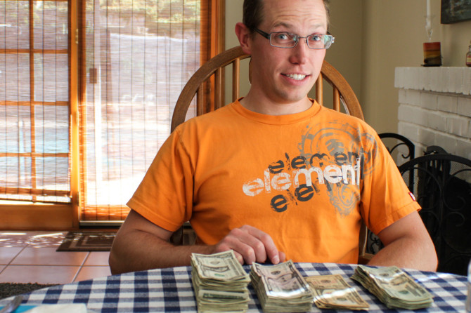 Landon with pile of money after selling everything at garage sales