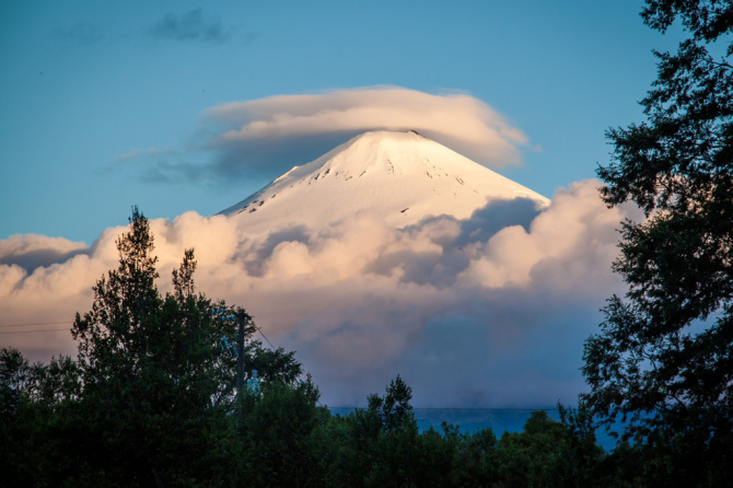 Volcano Villarica at Sunset with Clouds Around Base, in Chile